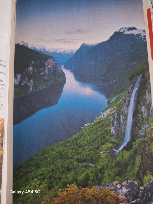 Scandinavia Lonely Planet guidebook image showcasing stunning fjord landscape in Norway with waterfalls.