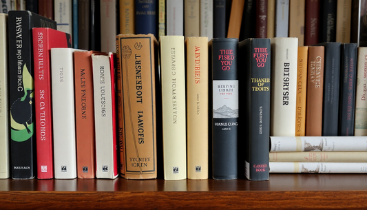 Collection of quality second-hand books UK on a wooden shelf with various titles and authors