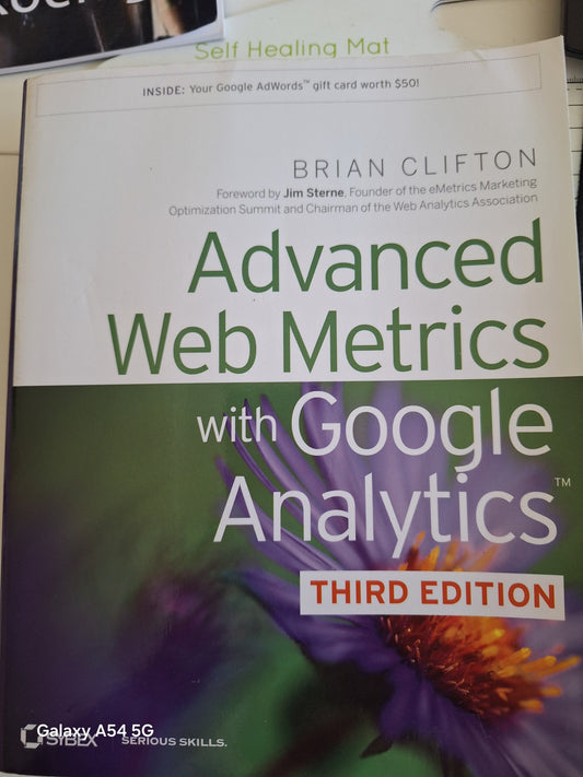 Advanced web metrics book by Brian Clifton with Google Analytics third edition cover showing purple flower