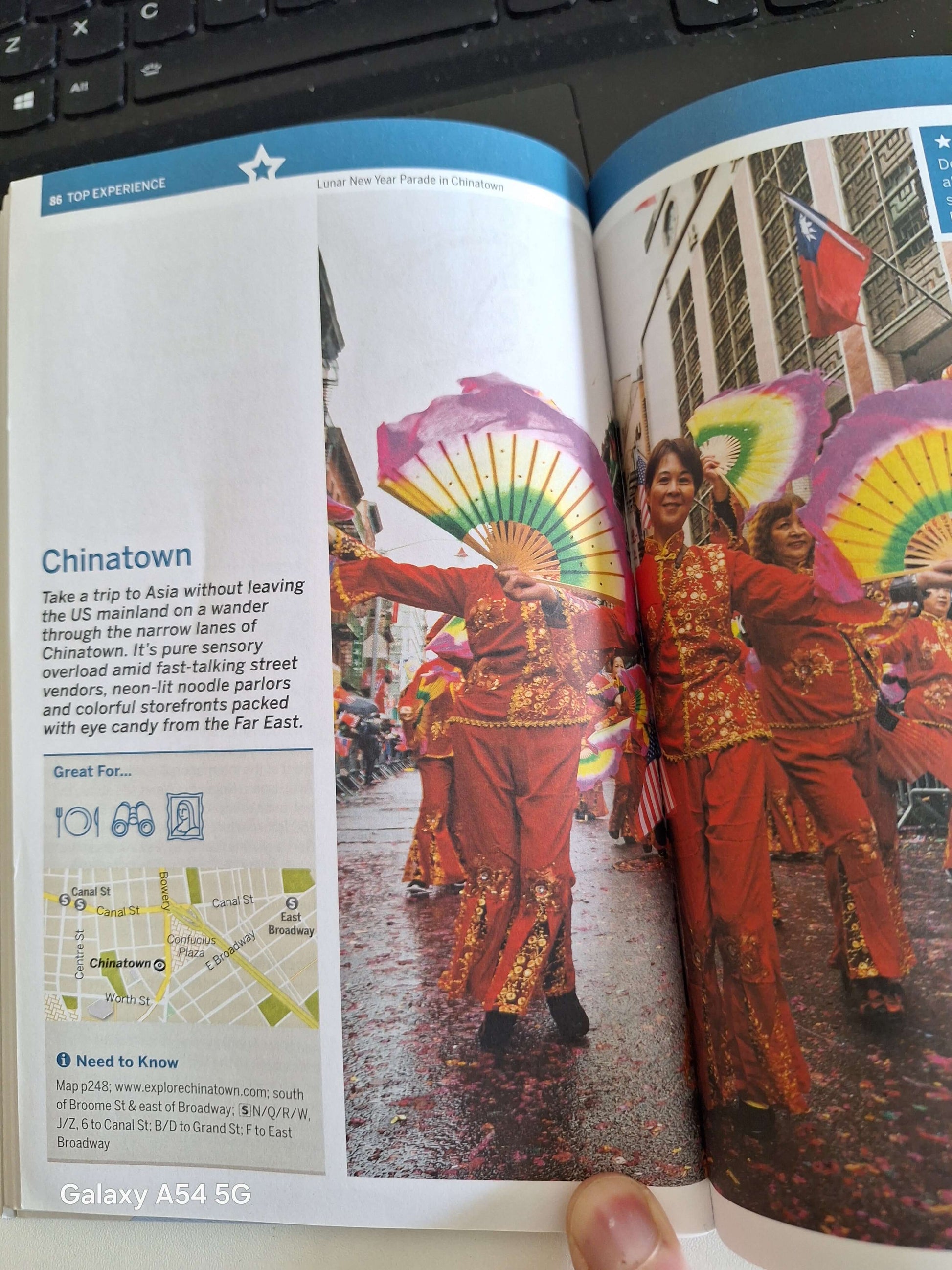 Chinatown festival page from Lonely Planet NYC guidebook showing cultural parade in vibrant colours. Buy used Lonely Planet NYC.