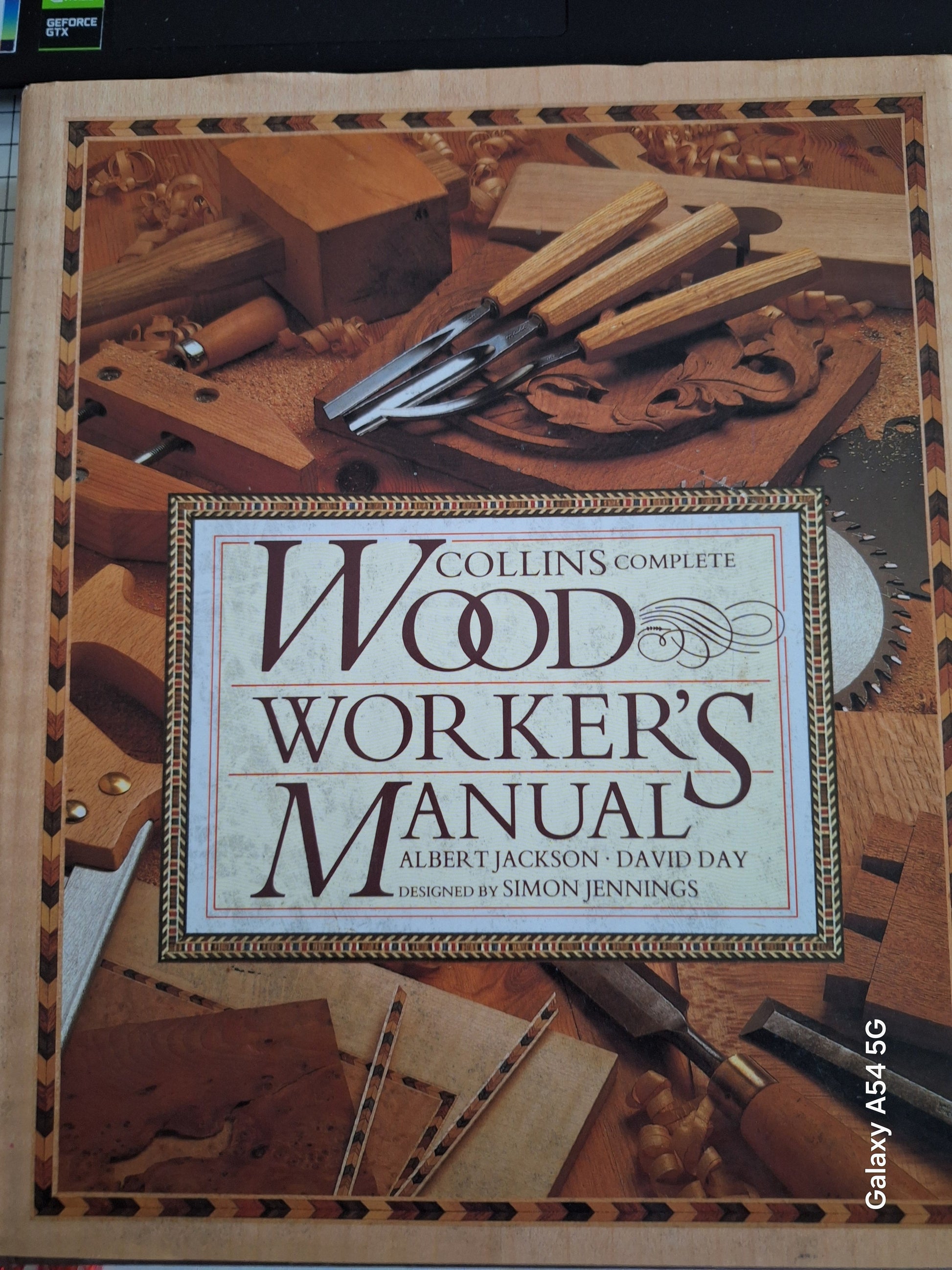 Collins complete woodworker's manual book cover with woodworking tools and wood pieces in the background