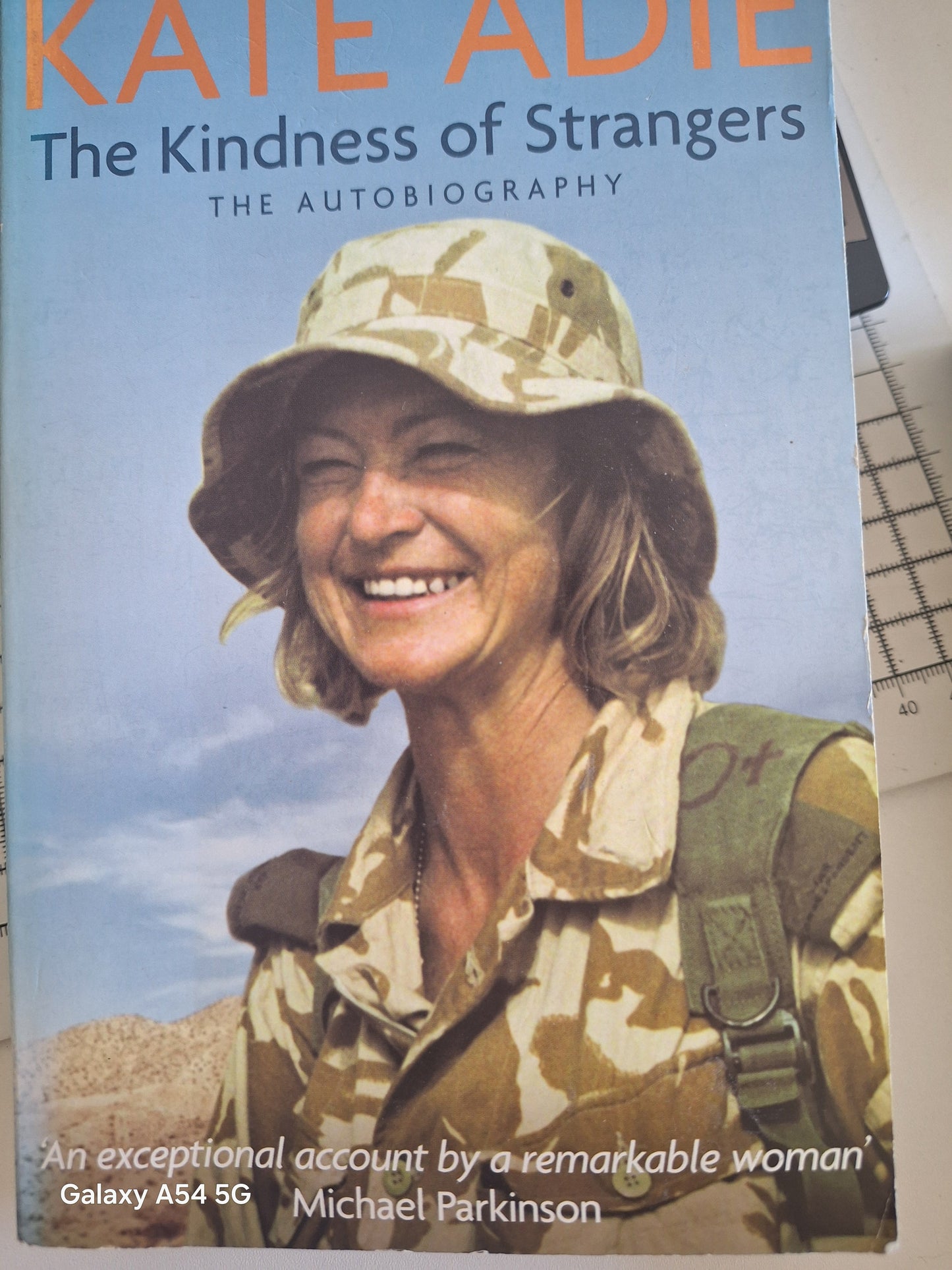 Cover of Kate Adie autobiography titled The Kindness of Strangers featuring Kate Adie in military attire
