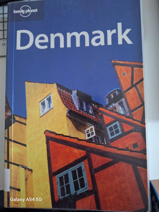 Lonely Planet Denmark guidebook featuring vibrant colours and architecture on the cover