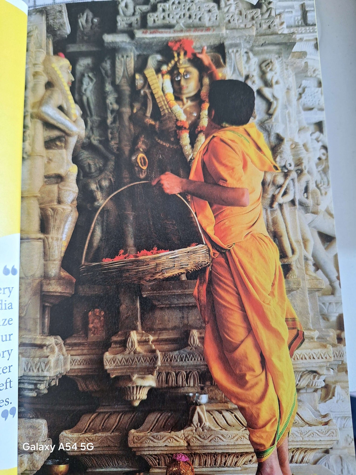 Lonely Planet Discover India guidebook featuring a devotee at a Hindu temple with intricate carvings