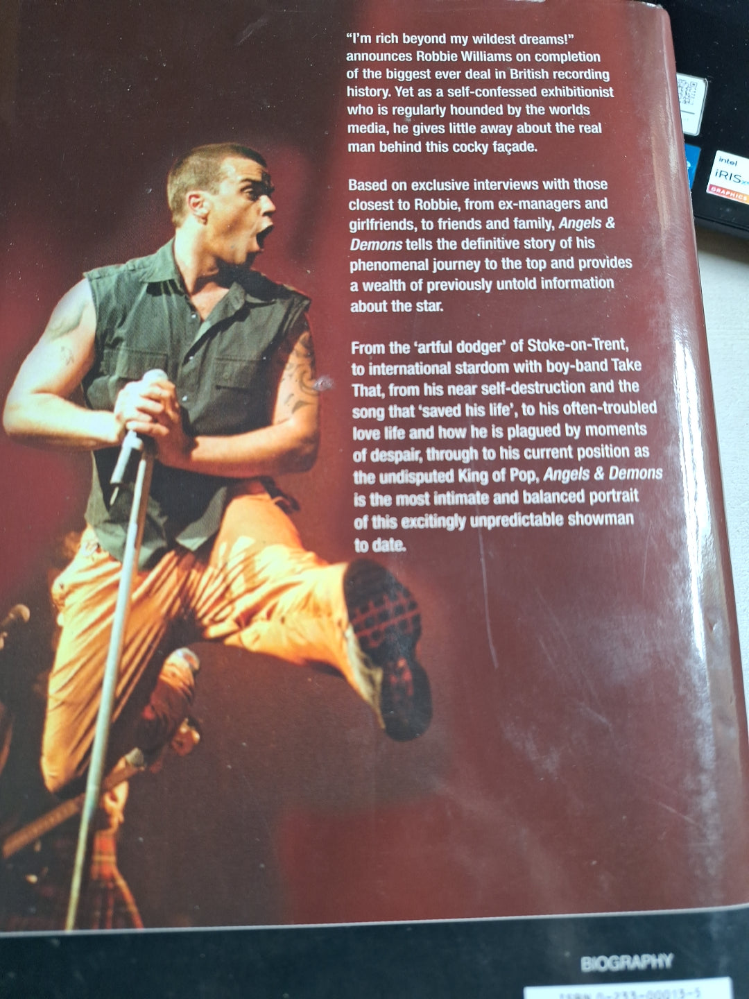 Hardcover Robbie Williams book featuring biography and exclusive interviews about his life and career