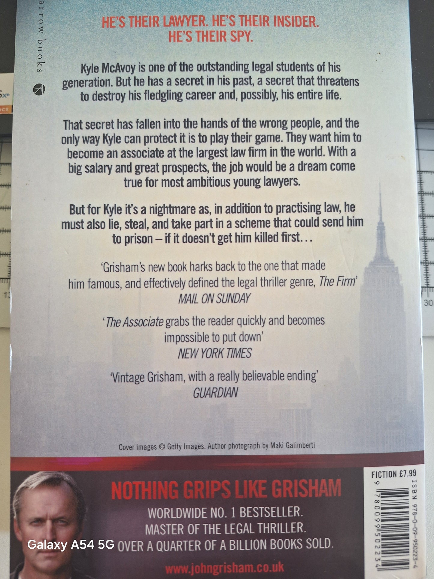 Used John Grisham The Associate book back cover featuring reviews and author details