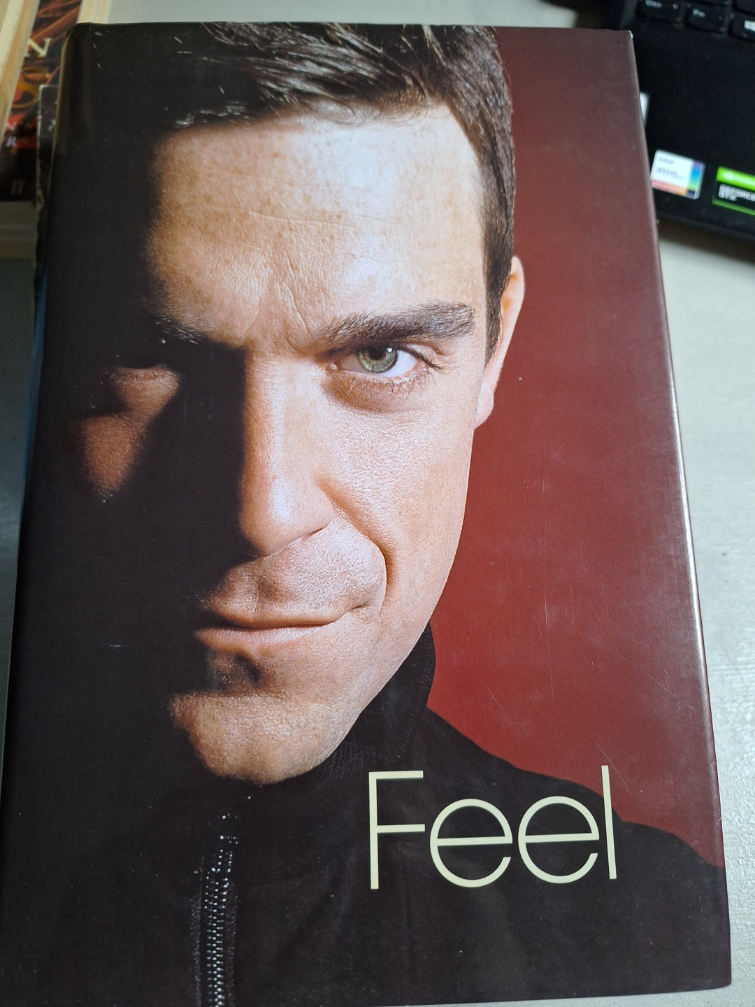 Used Robbie Williams biography titled Feel with close-up portrait of Robbie Williams on the cover