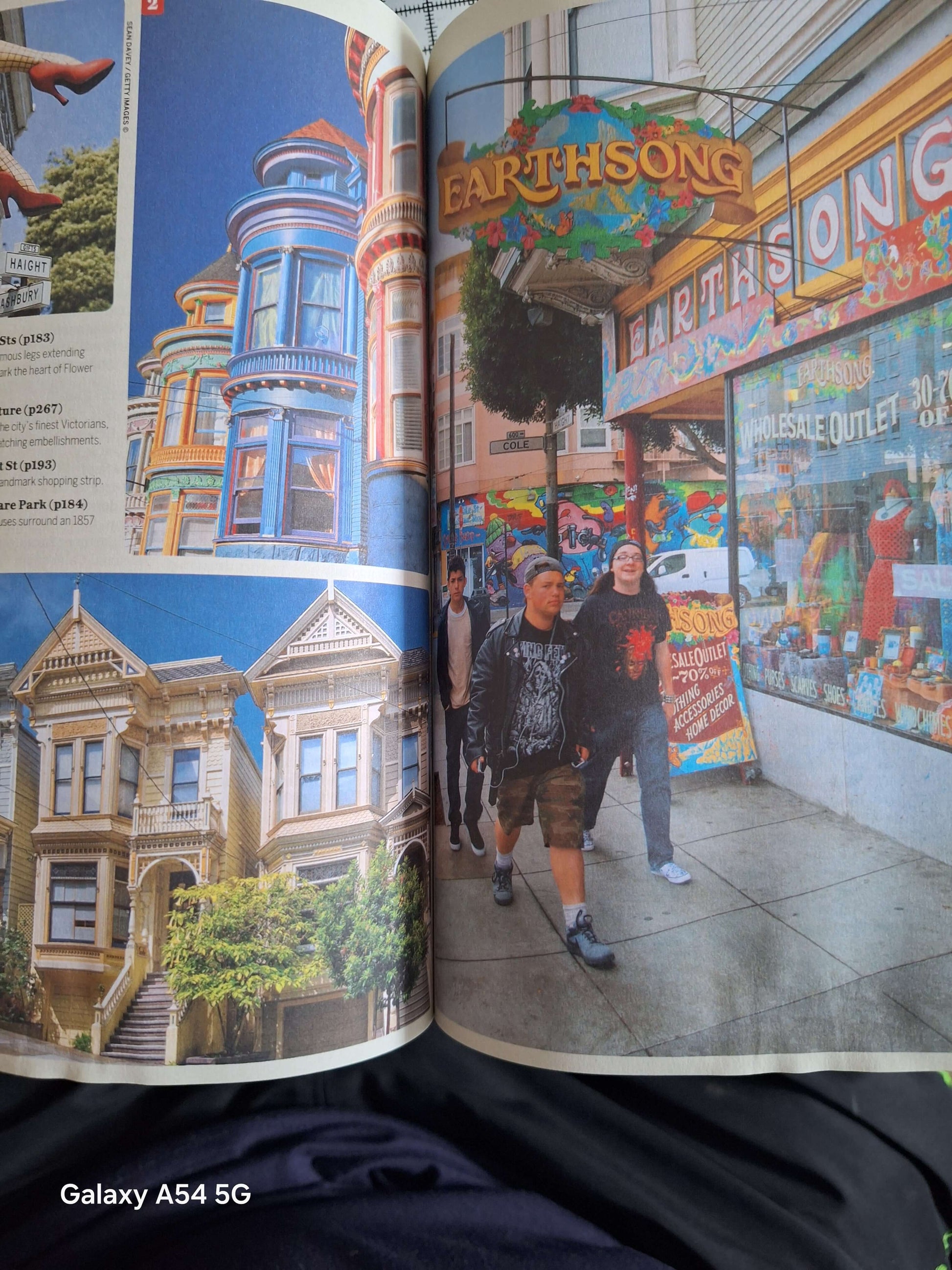 Open used San Francisco travel book showcasing vibrant street scenes and colourful buildings in the city