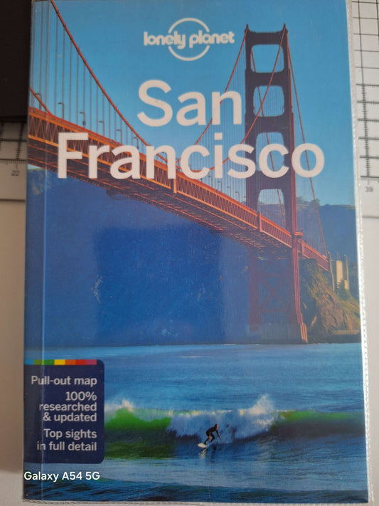 Used San Francisco travel book featuring the Golden Gate Bridge and a surfer on the cover